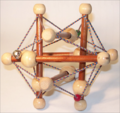 6 strut tensegrity toy with beads and bell smaller.png